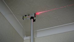 Locating ceiling joists with the help of a bradawl and a laser