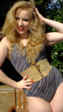 Sunshine girl KVV (Kristina) poses in the garden, modelling vintage M&S tummy-control swimsuit and tight corset belt to nip in her waist