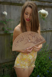 Josie Lauren relaxes in the garden between sets, in tight vintage Berlei corselette