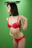 Olive Cartley modelling red love bikini, shows off her tiny waist and tucked-in tummy, while performing her deportment exercises
