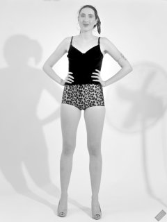 2026-08-01 Estella Rose models her own black sleeveless top and tight animal-print retro girdle worn as hotpants.
