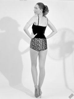 2026-08-01 Estella Rose models her own black sleeveless top and tight animal-print retro girdle worn as hotpants.