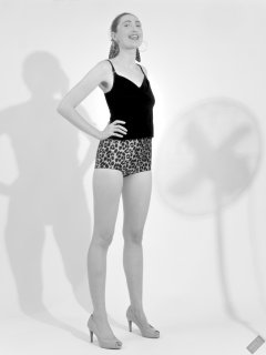 2026-08-01 Estella Rose models her own black sleeveless top and tight animal-print retro girdle worn as hotpants.
