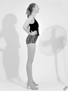 2026-08-01 Estella Rose models her own black sleeveless top and tight animal-print retro girdle worn as hotpants.