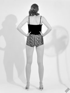 2026-08-01 Estella Rose models her own black sleeveless top and tight animal-print retro girdle worn as hotpants.