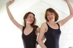 Chiara and Debbie in black one-piece swimsuits