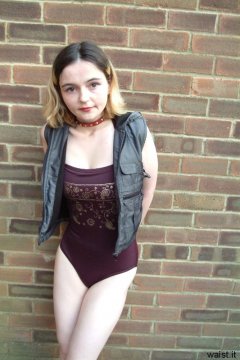 Annie posing in maroon one-piece swimsuit