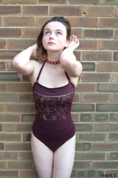 Annie posing in maroon one-piece swimsuit