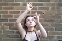 Annie posing in maroon one-piece swimsuit