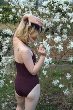 Annie in the garden modelling maroon one-piece swimsuit