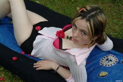 Annie modelling pink blouse tied at the waist, and tight zip-front panty-girdle