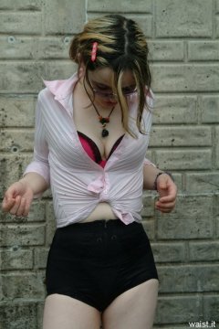 Annie modelling pink blouse tied at the waist + zip-front panty-girdle