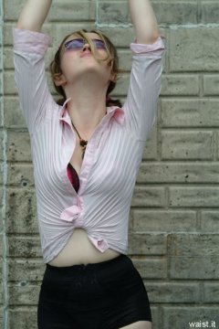 Annie modelling pink blouse tied at the waist + zip-front panty-girdle