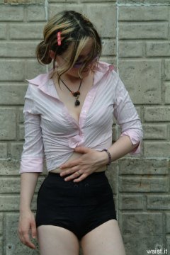 Annie modelling pink blouse tied at the waist + zip-front panty-girdle
