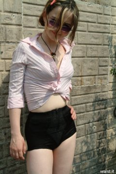 Annie modelling pink blouse tied at the waist + zip-front panty-girdle
