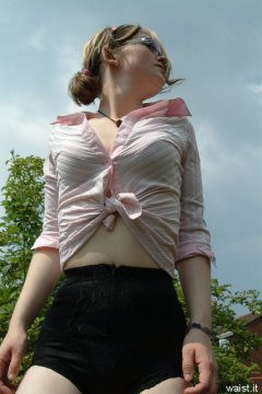 Annie modelling pink blouse tied at the waist + zip-front panty-girdle