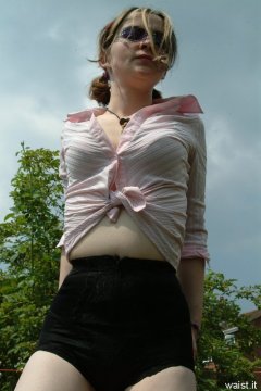 Annie modelling pink blouse tied at the waist + zip-front panty-girdle