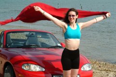 Chiara at Tanners Lane Beach with red Mazda MX5