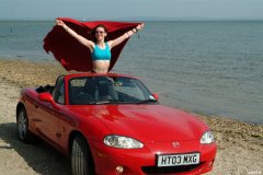 Chiara at Tanners Lane Beach with red Mazda MX5