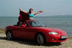 Chiara at Tanners Lane Beach with red Mazda MX5