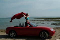 Chiara at Tanners Lane Beach with red Mazda MX5