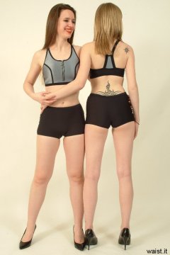 Chiara and Carlie pose in matching sportswear tops and hot pants