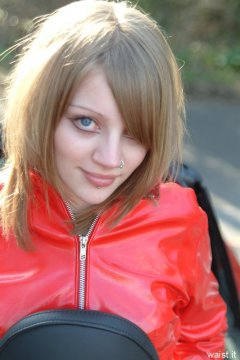 Carlie models red PVC jacket.
