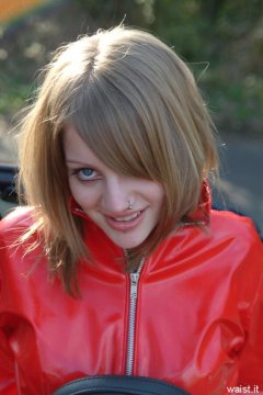 Carlie models red PVC jacket.
