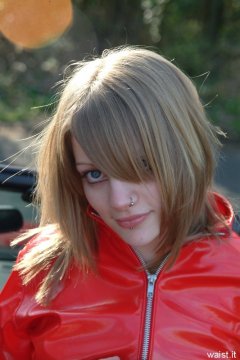 Carlie models red PVC jacket.