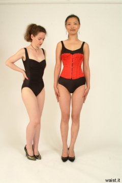 Chiara admires her handiwork - Moonlit Jane tightly laced up all the way in a Red Vollers corset.