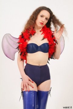 Chiara in matching blue bra and vintage style pantie girdle, with feather boa