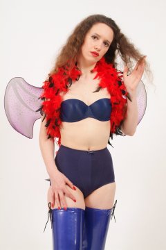 Chiara in matching blue bra and vintage style pantie girdle, with feather boa