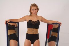 Sara with mirrors in black strapless bra, girdle and suede corset-belt