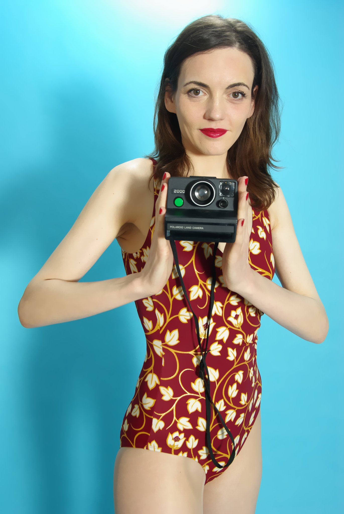 Anise in vintage-style tummy-control one-piece swimsuit,with Polaroid camera