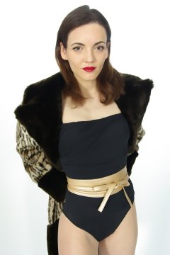 Anise in black vintage-style one-piece swimsuit and fur coat