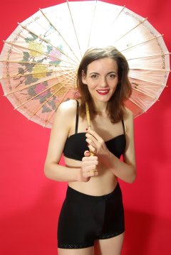Anise in black bra worn as a top and and vintage pantie girdle worn as hotpants