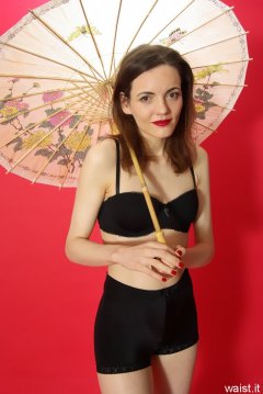 Anise in black bra worn as a top and and vintage pantie girdle worn as hotpants