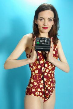 Anise in vintage-style tummy-control one-piece swimsuit,with Polaroid camera