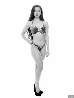 Charlene Joy posing in her fitness competition bikini