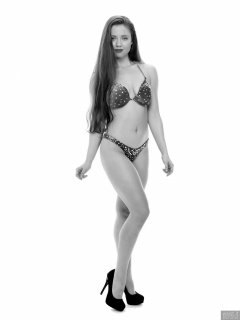 Charlene Joy posing in her fitness competition bikini