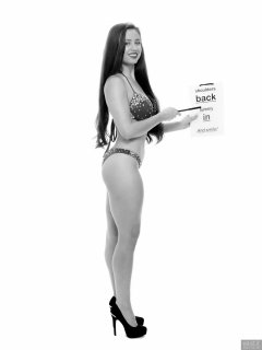 Charlene Joy posing in her fitness competition bikini