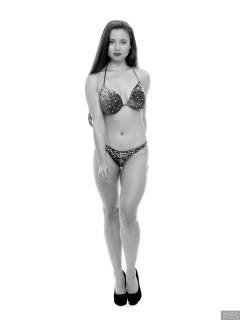 Charlene Joy posing in her fitness competition bikini