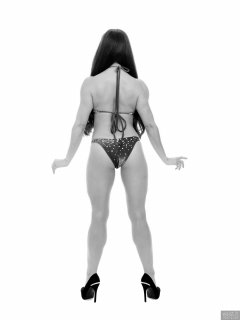 Charlene Joy posing in her fitness competition bikini