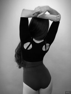 Charlene Joy in black bra and posture top, and purple high-waist control briefs worn as hotpants