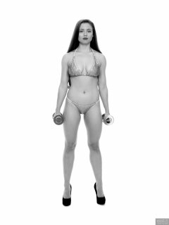 Charlene Joy weightlifting still, in her fitness competition bikini
