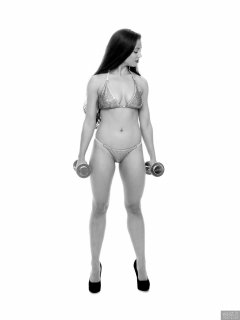 Charlene Joy weightlifting still, in her fitness competition bikini