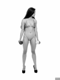 Charlene Joy weightlifting still, in her fitness competition bikini