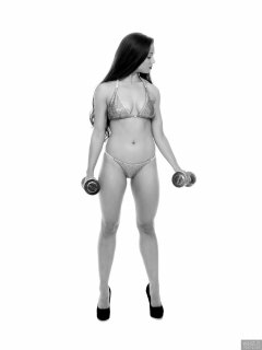 Charlene Joy weightlifting still, in her fitness competition bikini