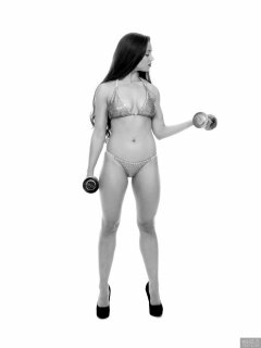 Charlene Joy weightlifting still, in her fitness competition bikini