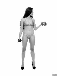 Charlene Joy weightlifting still, in her fitness competition bikini